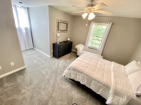 7404 Hoods Branch Road Springfield, TN 37172 - Photo 28 of 50 a bed room with a bed and a chandelier