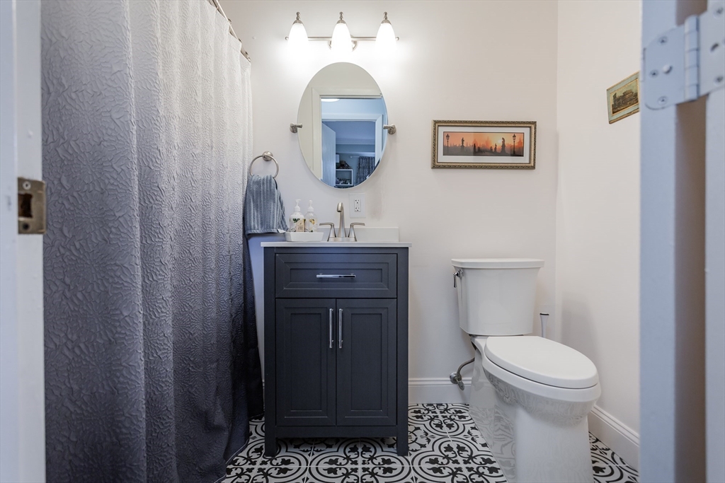 4700 North Main Street, Unit 1K Fall River, MA 02720 - Photo 14 of 18 a bathroom with a toilet a sink and mirror
