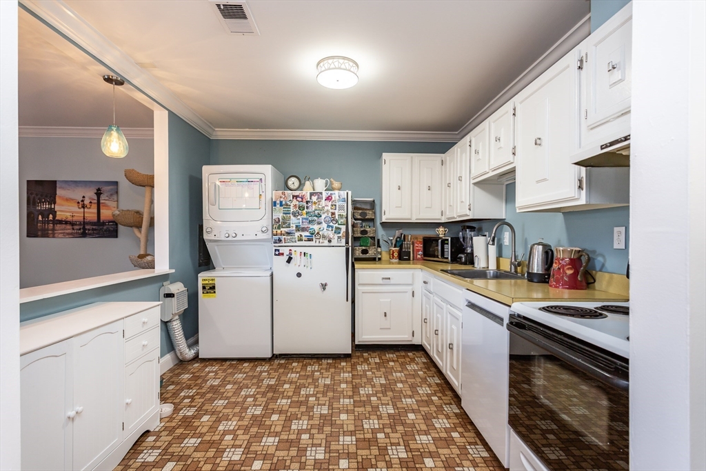 4700 North Main Street, Unit 1K Fall River, MA 02720 - Photo 6 of 18 a kitchen with white cabinets and appliances