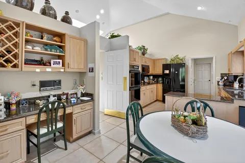 a kitchen with stainless steel appliances kitchen island granite countertop a sink and cabinets