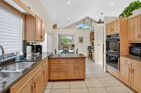 a kitchen with stainless steel appliances granite countertop a sink and cabinets