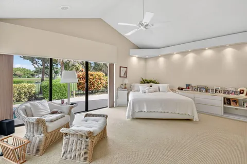 a spacious bedroom with a bed and large window