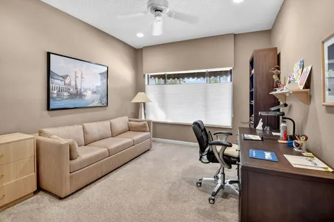 a living room with furniture and a desk