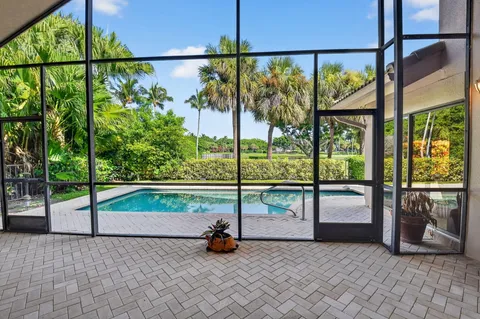 an aerial view of residential house with outdoor space and swimming pool