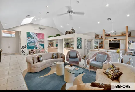a living room with furniture kitchen view and a chandelier
