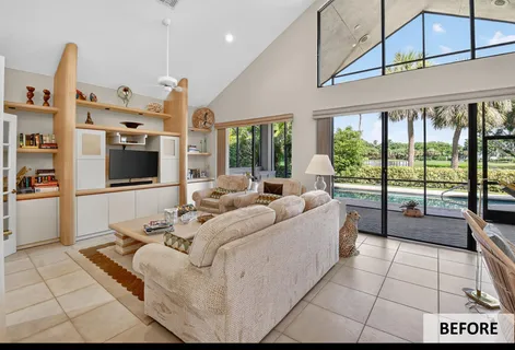 a living room with furniture a flat screen tv and a floor to ceiling window