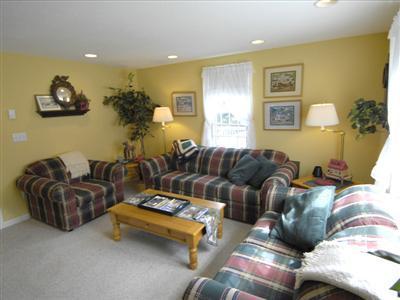 223 Rock Harbor Road, Unit D Orleans, MA 02653 - Photo 4 of 8 a living room with furniture and a table