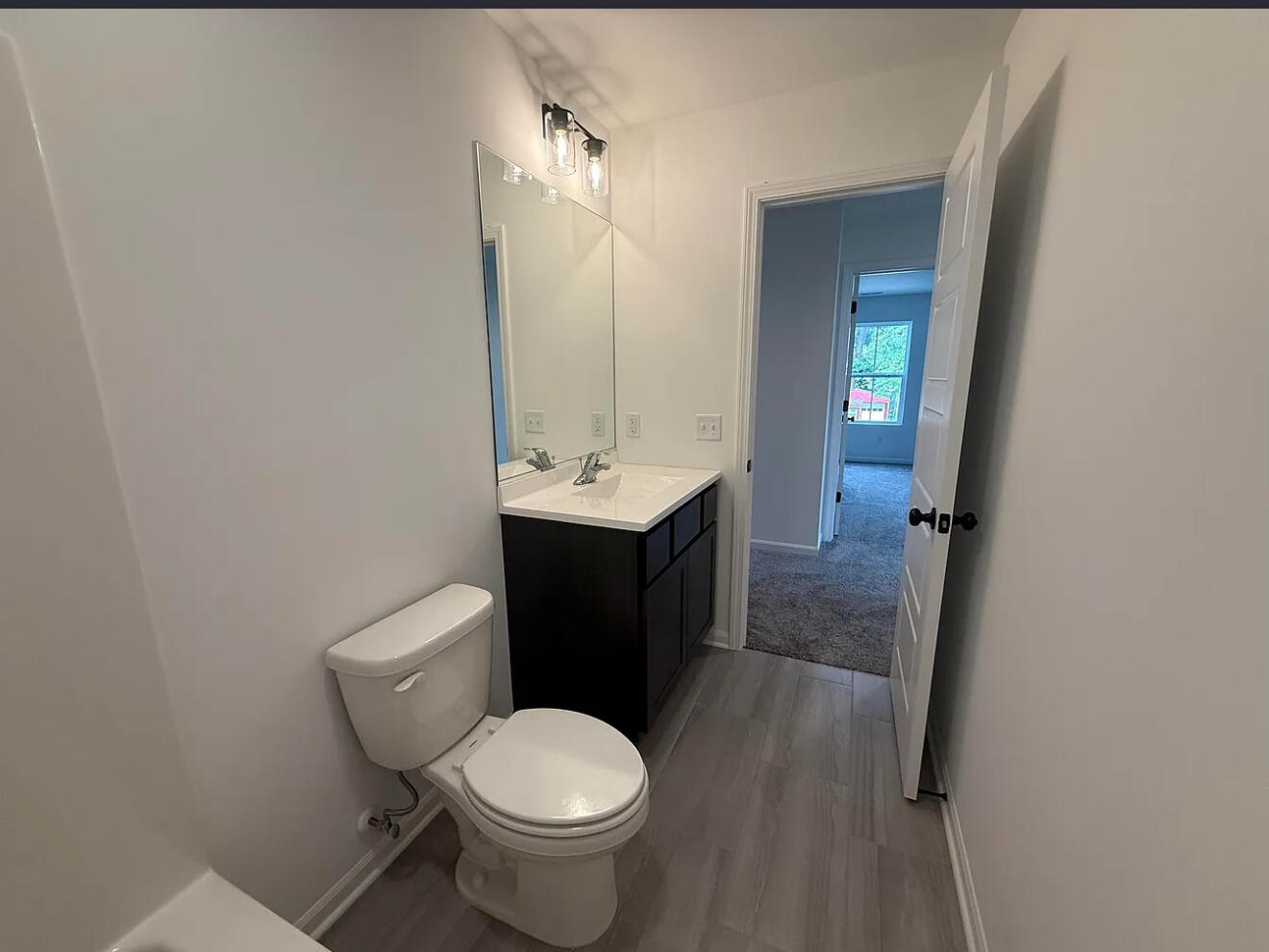 717 Lake Street Hobart, IN 46342 - Photo 17 of 25 a bathroom with a sink and a toilet