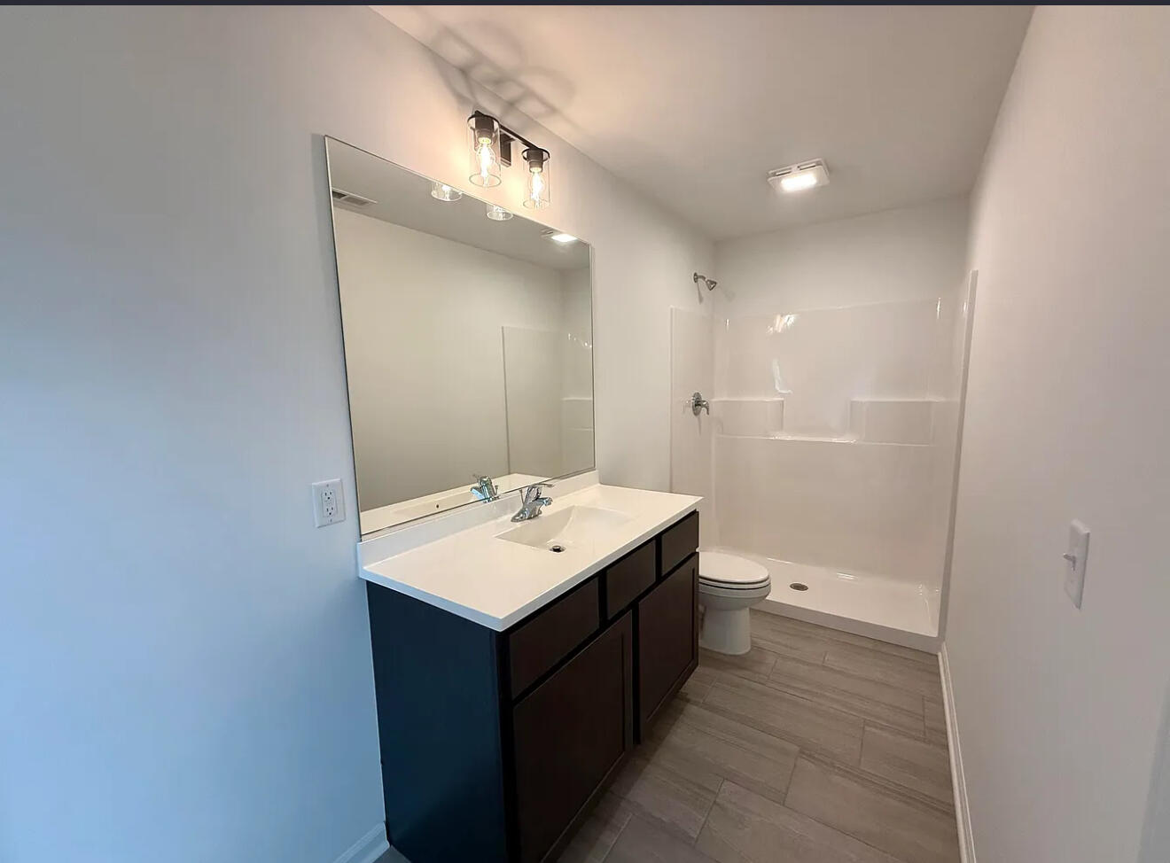 717 Lake Street Hobart, IN 46342 - Photo 20 of 25 a bathroom with a sink a toilet and shower