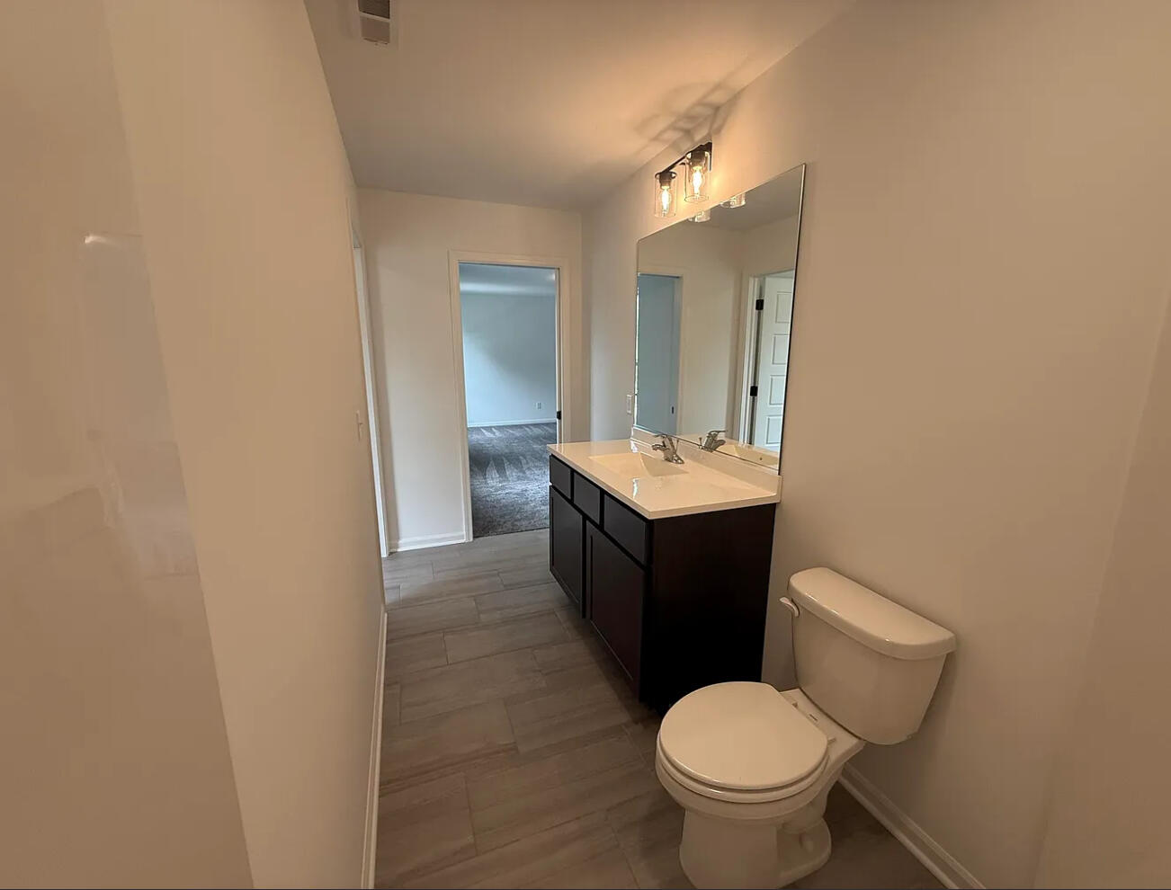 717 Lake Street Hobart, IN 46342 - Photo 21 of 25 a bathroom with a toilet sink and mirror
