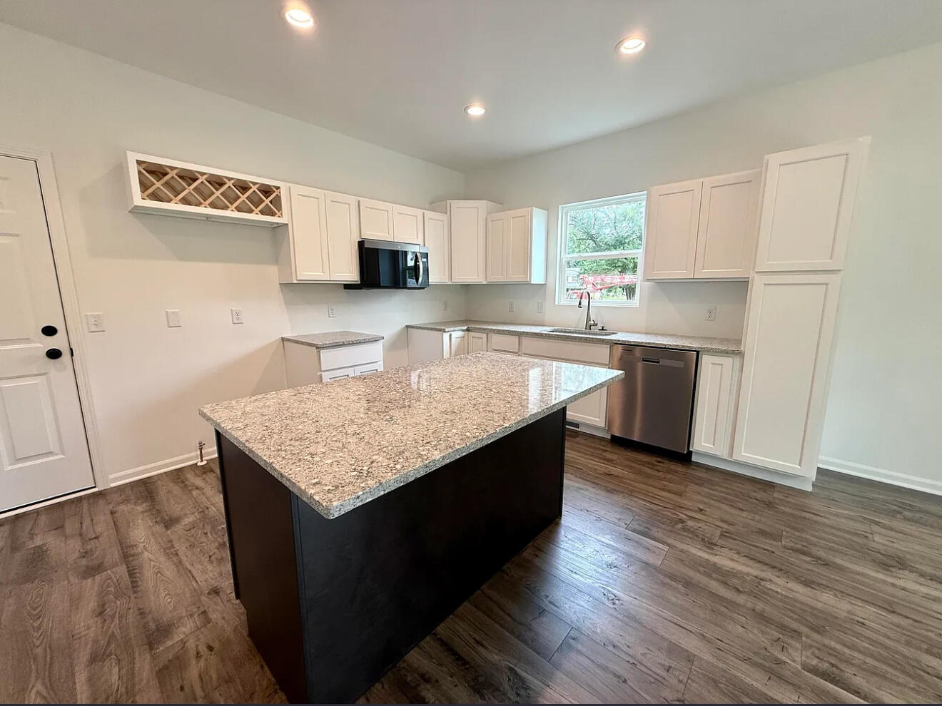 717 Lake Street Hobart, IN 46342 - Photo 8 of 25 a kitchen with stainless steel appliances granite countertop a sink dishwasher a refrigerator and white cabinets with wooden floor