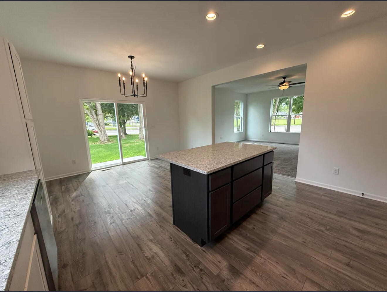 717 Lake Street Hobart, IN 46342 - Photo 9 of 25 a living room with kitchen island granite countertop wooden floor and a fireplace