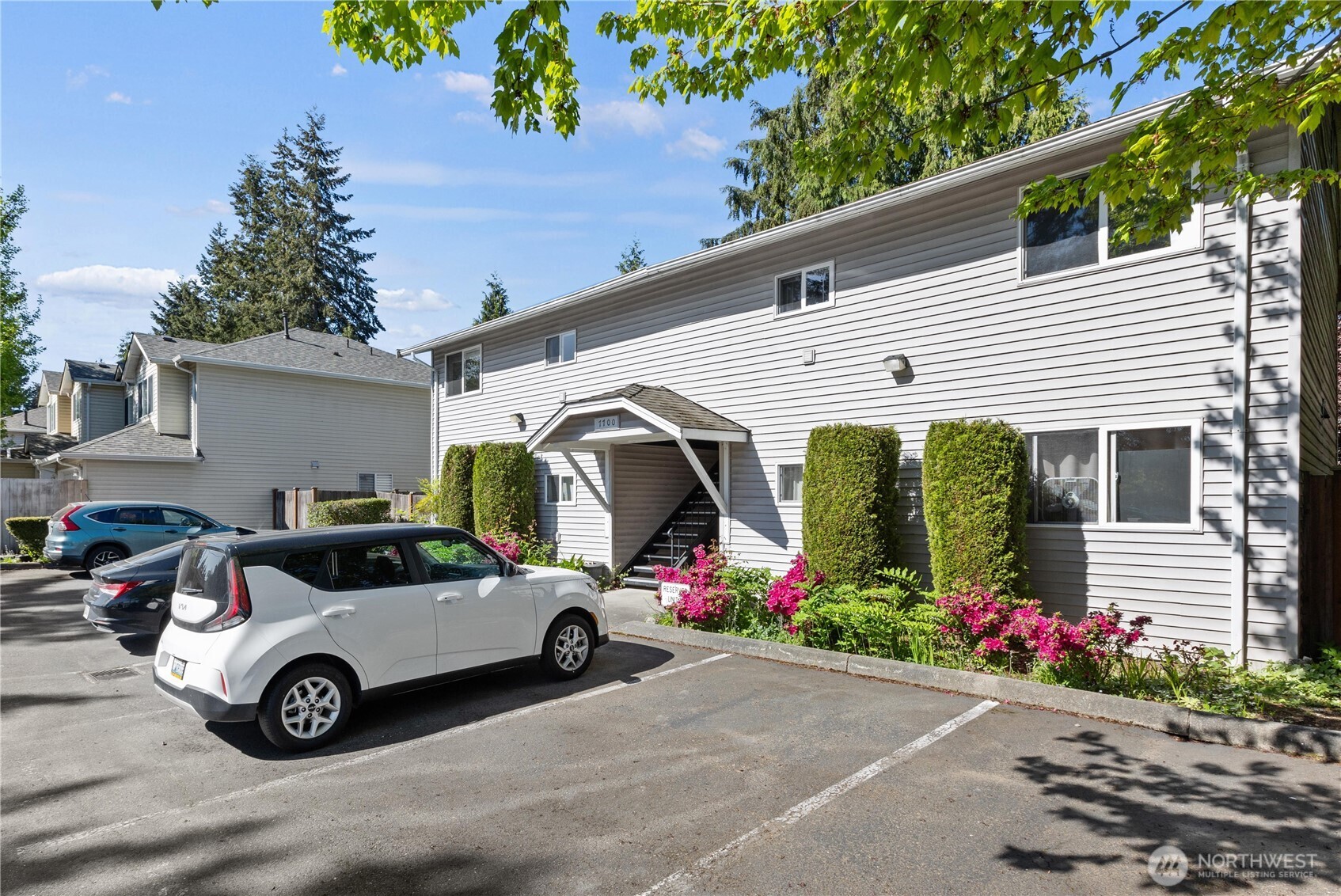7700 196th Street Southwest, Unit C Edmonds, WA 98036 - Photo 1 of 26 a view of parking area with cars parked