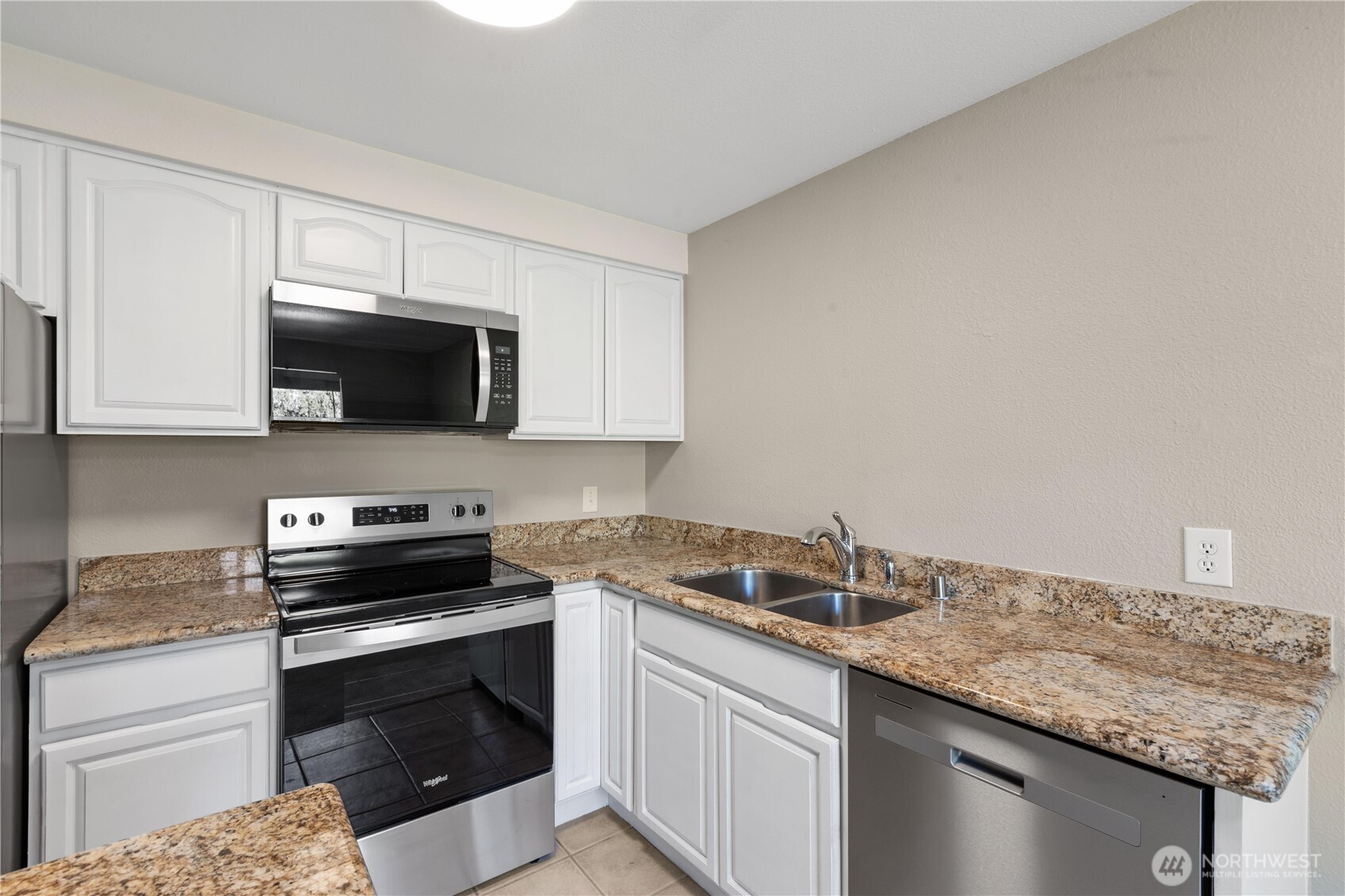 7700 196th Street Southwest, Unit C Edmonds, WA 98036 - Photo 13 of 26 a kitchen with granite countertop a sink and a stove
