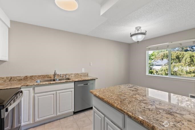 7700 196th Street Southwest, Unit C Edmonds, WA 98036 - Photo 15 of 26 a kitchen with a sink and cabinets