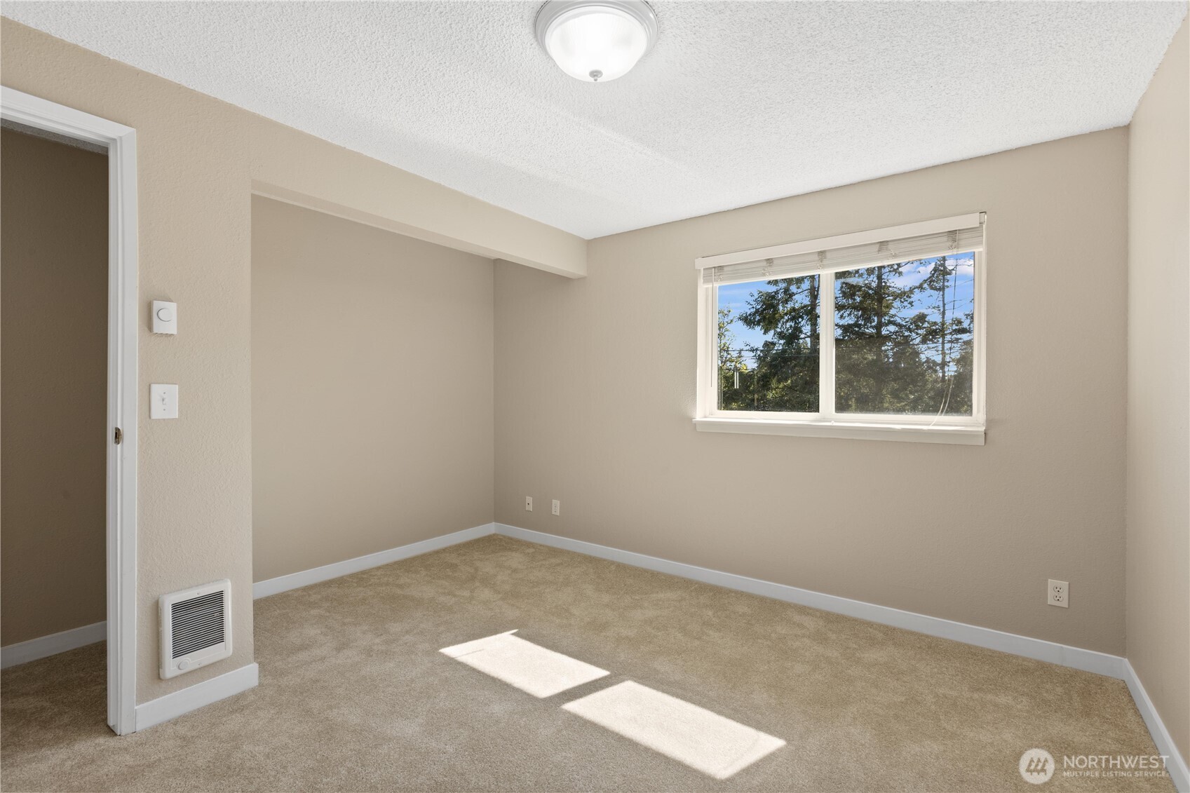 7700 196th Street Southwest, Unit C Edmonds, WA 98036 - Photo 21 of 26 an empty room with windows