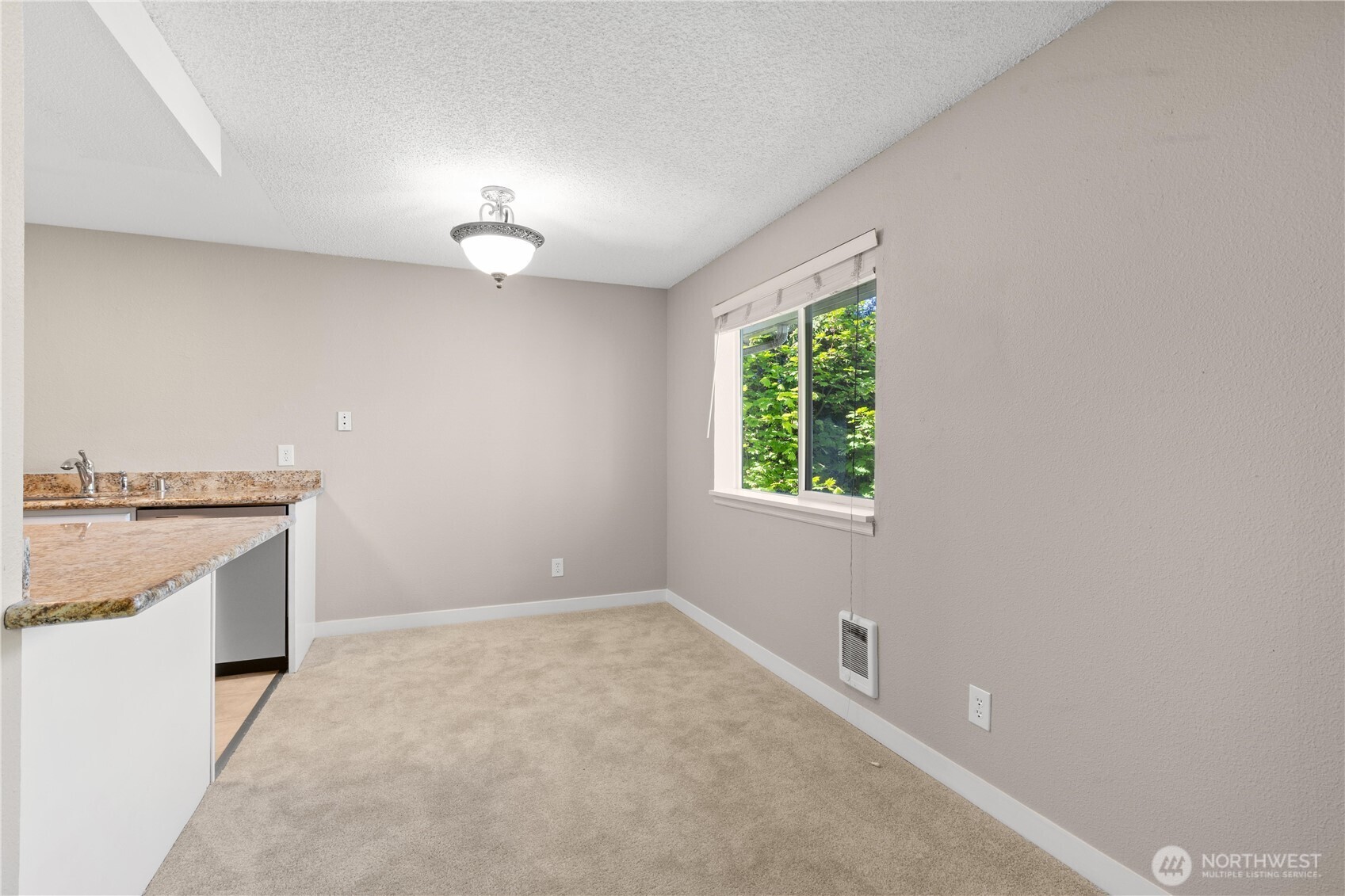 7700 196th Street Southwest, Unit C Edmonds, WA 98036 - Photo 8 of 26 an empty room with a stove and a window