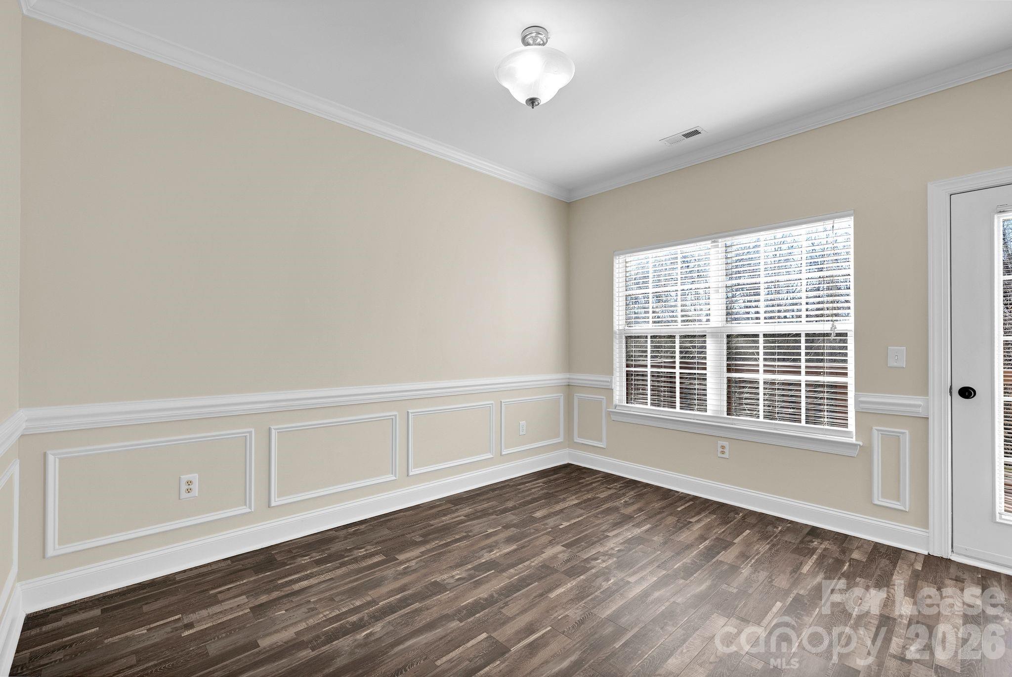 163 Forest Ridge Road Mooresville, NC 28117 - Photo 13 of 48 an empty room with wooden floor and windows
