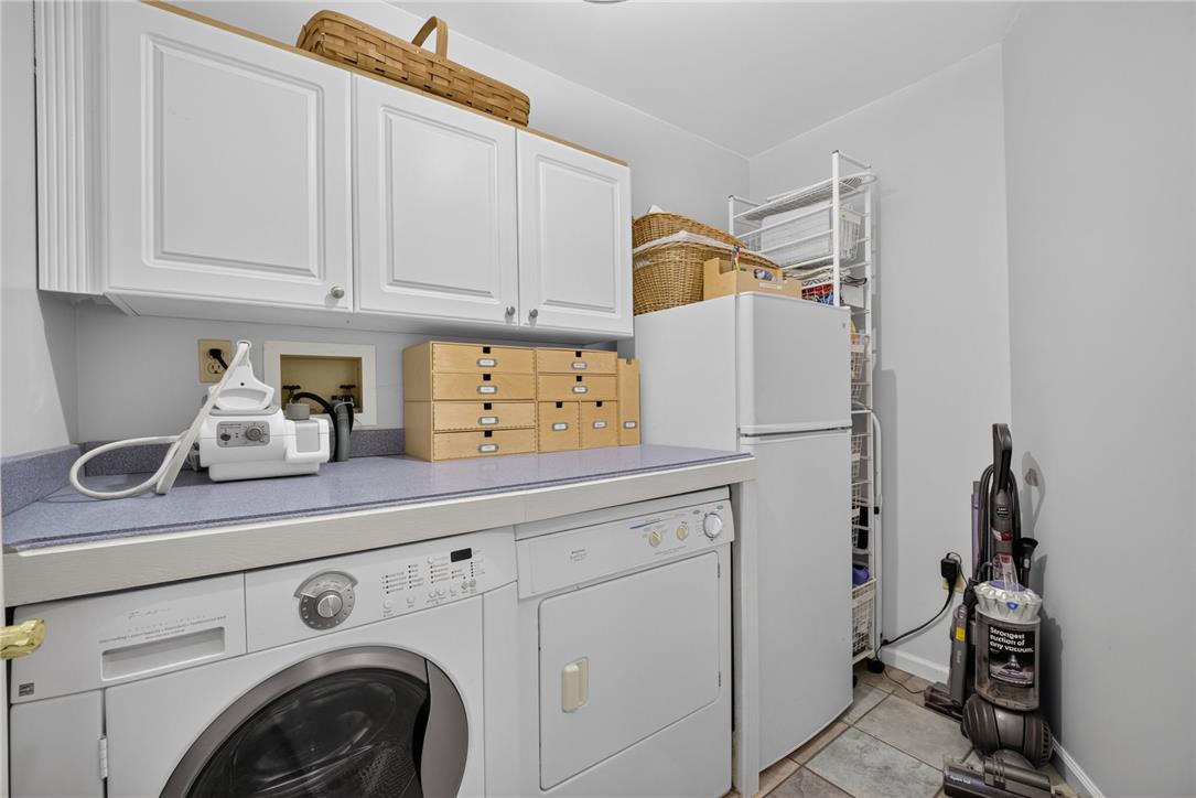 6467 Abbey Road Wind Gap, PA 18091 - Photo 38 of 46 Functional utility space boasts ample cabinetry and essential laundry appliances.