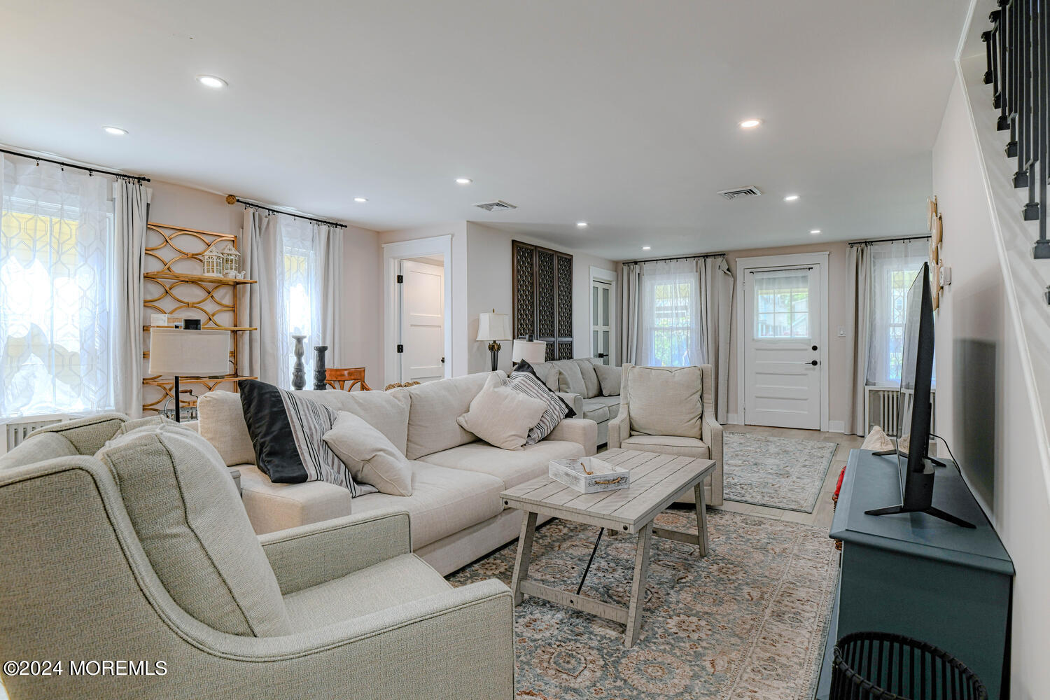 83 Broadway Ocean Grove, NJ 07756 - Photo 17 of 37 a living room with furniture a large window and a flat screen tv