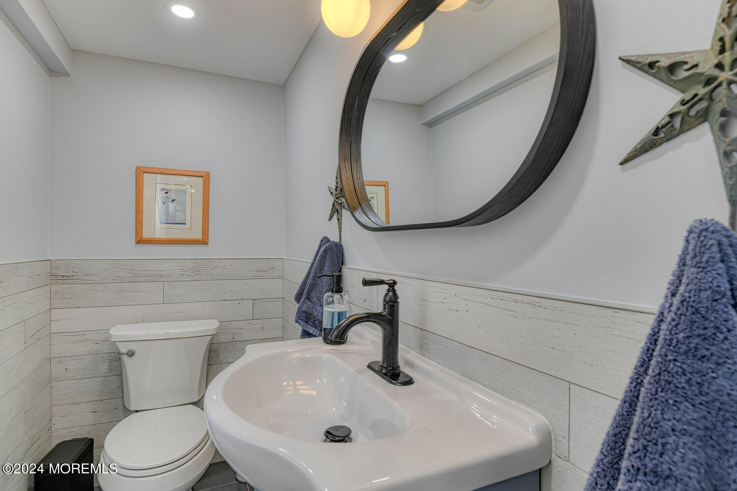 83 Broadway Ocean Grove, NJ 07756 - Photo 19 of 37 a bathroom with a sink and mirror