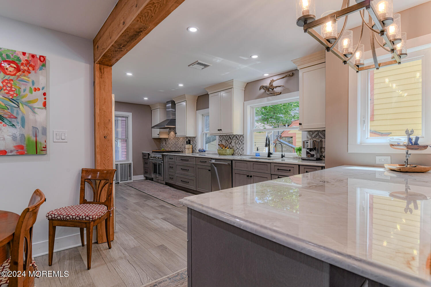 83 Broadway Ocean Grove, NJ 07756 - Photo 23 of 37 a kitchen with a table chairs microwave and cabinets