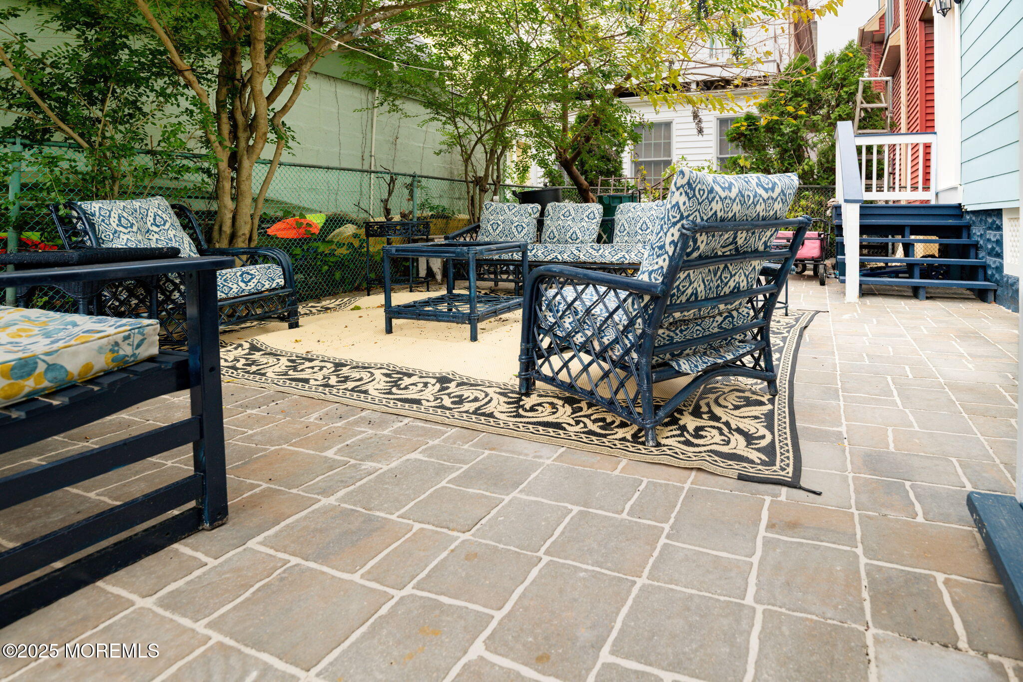 83 Broadway Ocean Grove, NJ 07756 - Photo 8 of 37 a view of a patio with dining table and chairs with wooden floor