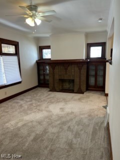 11509 Granger Road Cleveland, OH 44125 - Photo 5 of 16 Unfurnished living room featuring carpet flooring, plenty of natural light, a brick fireplace, and a ceiling fan