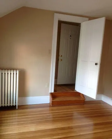 a view of a door and wooden floor