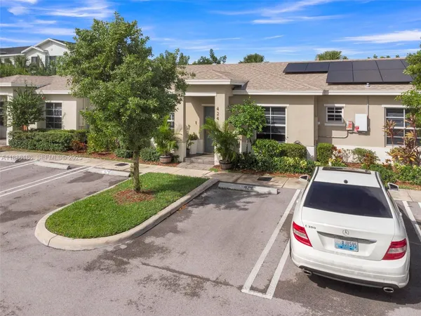 a kitchen with stainless steel appliances granite countertop a refrigerator a stove and a sink