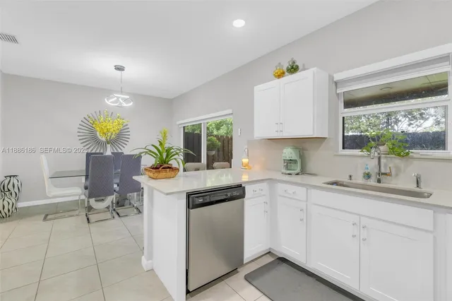 a kitchen with stainless steel appliances granite countertop a sink and a stove