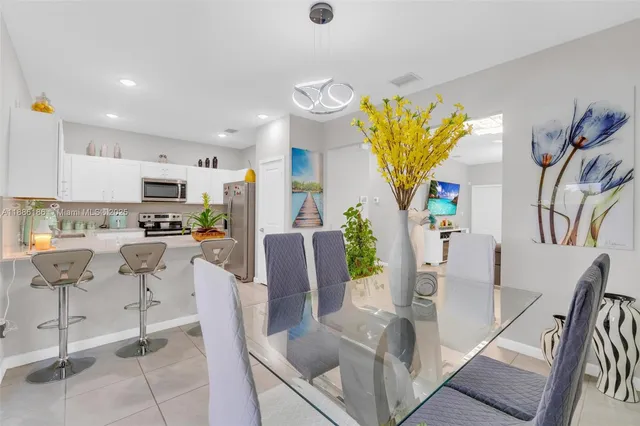 a kitchen with stainless steel appliances a stove a sink and a refrigerator