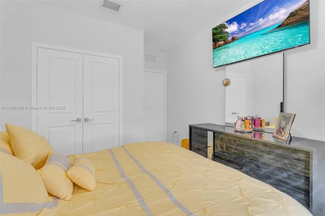 a bedroom with a bed and a dresser