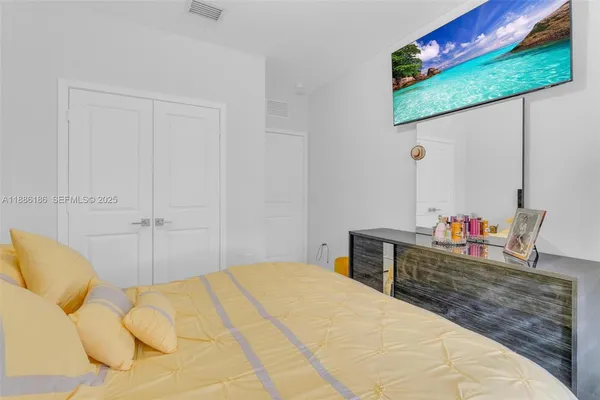 a bedroom with a bed and a dresser