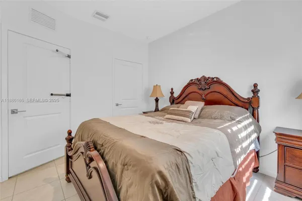a bedroom with a bed and a painting on the wall