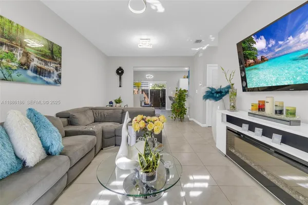 a living room with furniture and a flat screen tv
