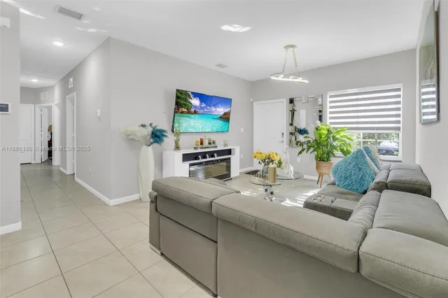a dining room with furniture and floor to ceiling window