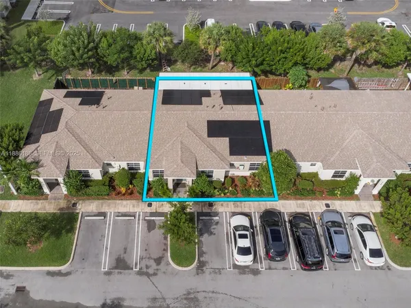 an aerial view of a house with garden space and lake view