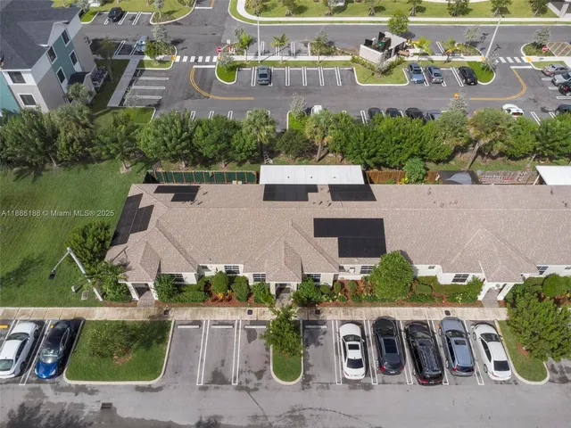 an aerial view of multiple houses with yard