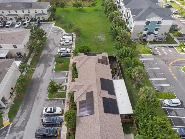 an aerial view of residential building and lake