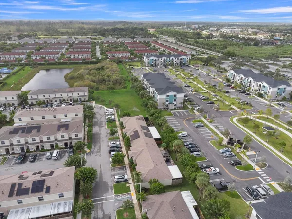 an aerial view of residential houses with outdoor space and river