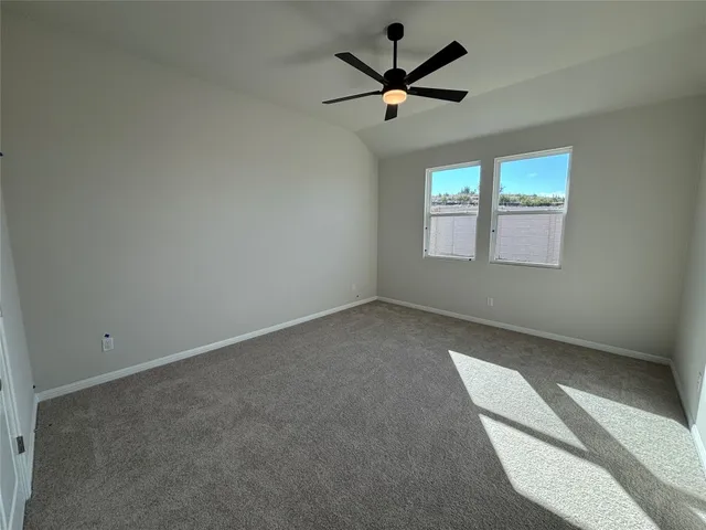 a view of an empty room with a ceiling fan