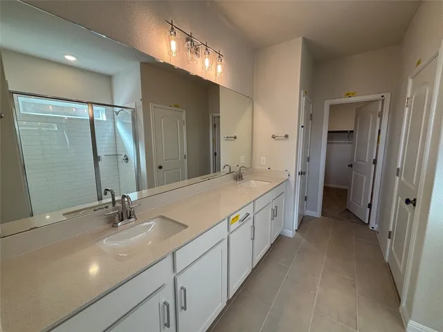 a bathroom with a shower and a sink