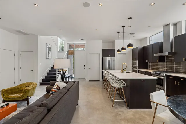a living room with furniture potted plant and a table