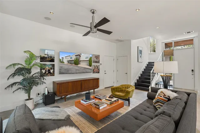 a living room with furniture and wooden floor
