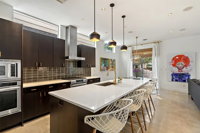 a kitchen that has a table and chairs in it