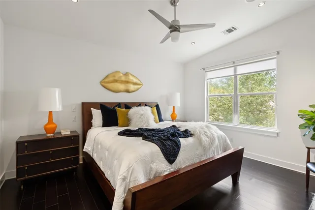 a bed sitting in a bedroom next to a window