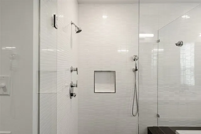 a bathroom with a tub sink and mirror