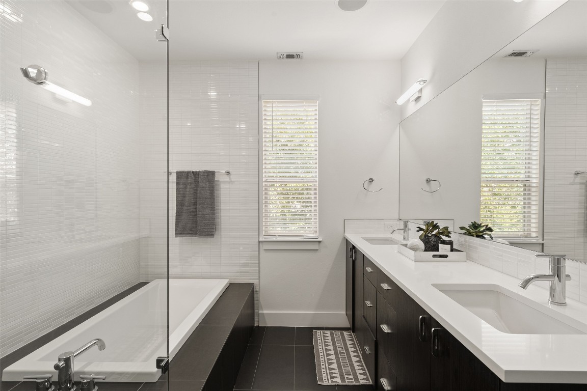 2105 Goodrich Avenue, Unit 2 Austin, TX 78704 - Photo 27 of 40 a bathroom with a tub sink and mirror
