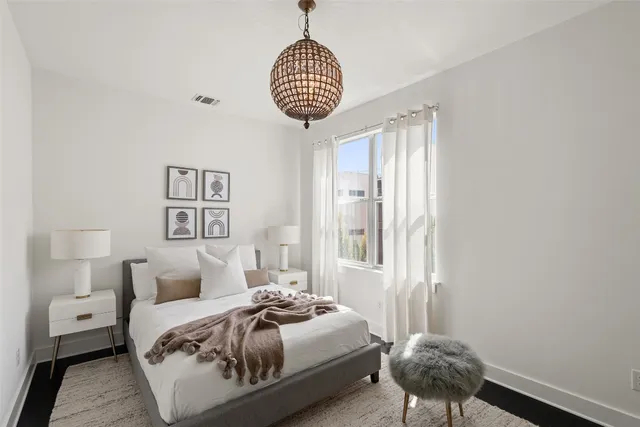 a bedroom with a bed and a large window